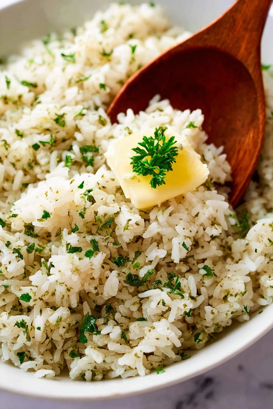 A large oval white plate filled with a single layer of cooked rice mixed with herbs, giving the rice a light brown and green speckled texture. The rice looks soft and fluffy, with small bits of parsley scattered evenly on top. In the center, there is a small dollop of butter melting into the rice, adding a slight creamy shine. A wooden spoon rests on the right edge of the plate, partially under the rice. The background shows a soft-focus light-colored cloth and a white marbled surface under the plate. photo taken with an iphone --ar 2:3 --v 7