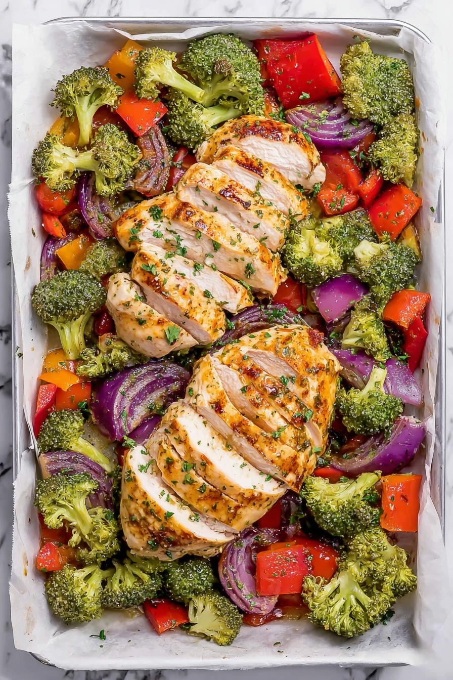 The image shows a white rectangular baking tray lined with white parchment paper. On the tray, there are two main parts: in the center, two pieces of sliced cooked chicken arranged in a row with golden brown grill marks on top, and around the chicken, a colorful mix of vegetables including bright green broccoli florets, large chunks of red bell pepper, and pieces of purple onion. The vegetables look slightly roasted with some texture, and the entire dish is sprinkled with small green herbs. The background is a white marbled surface. Photo taken with an iphone --ar 2:3 --v 7