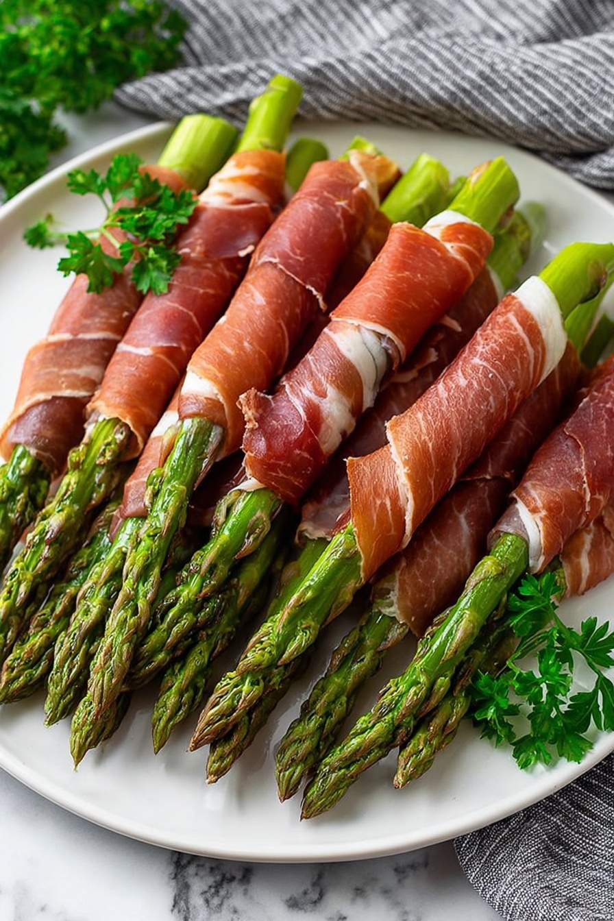 A white plate holds a neat pile of green asparagus stalks, each wrapped in thin, reddish-brown slices of cured meat. The asparagus tips are bright green and slightly textured, while the meat has a slightly shiny, smooth surface with some darker and lighter spots showing its thin layers. Small sprigs of fresh green parsley are placed at the side of the plate for decoration. The plate sits on a white marbled surface with part of a grey and white striped cloth visible in the background. photo taken with an iphone --ar 2:3 --v 7