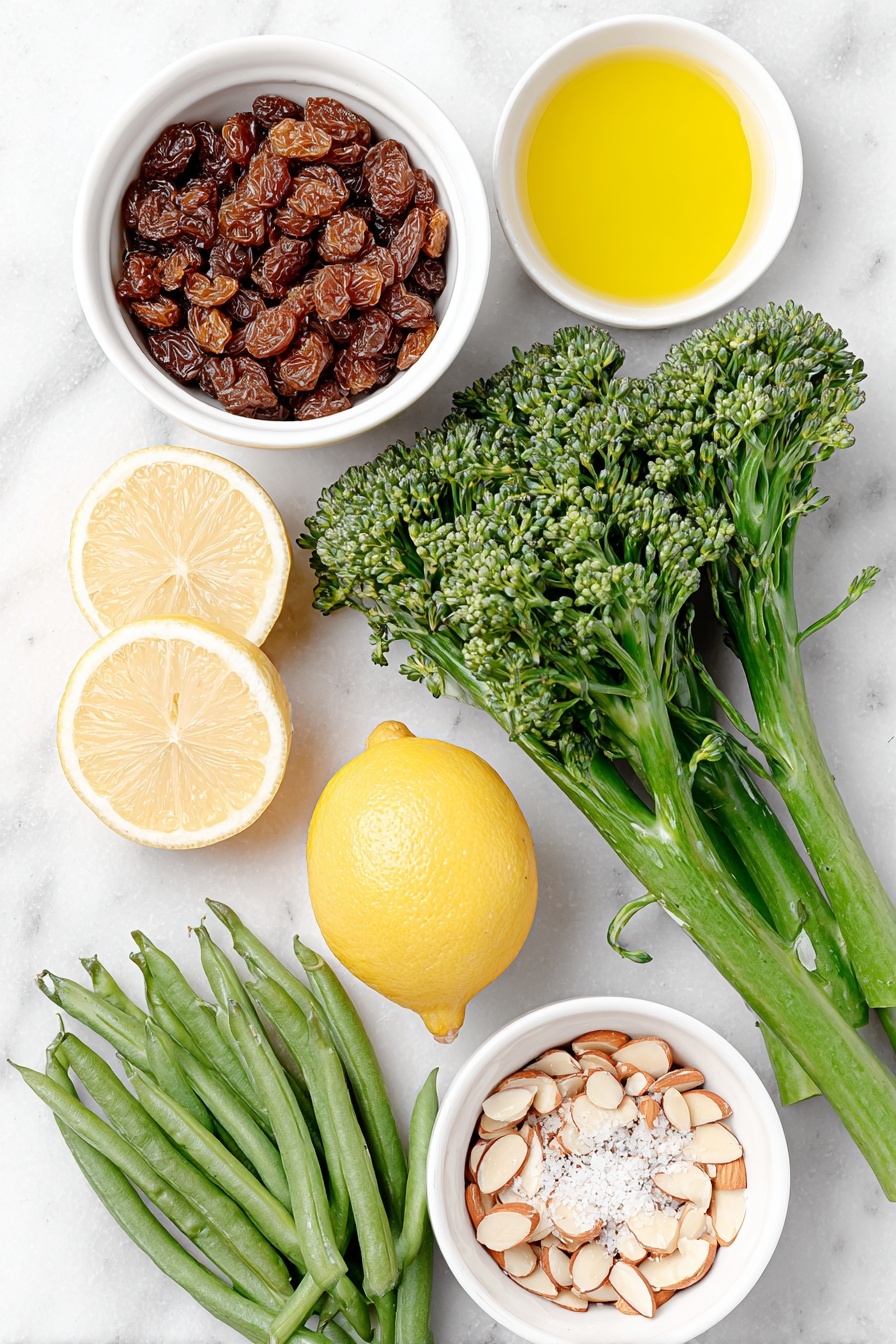 Flat lay of dried currants in a small white bowl, a small white bowl filled with golden olive oil, fresh whole lemon halved with bright yellow peel strips, two smashed garlic cloves with papery skin removed, a bunch of vibrant green broccolini with trimmed ends, a handful of fresh green beans with stem ends removed, a small white bowl of water, a small white bowl of fresh lemon juice, and a small white bowl of light brown toasted almond slices, arranged symmetrically with perfect proportions, placed on a clean white marble surface, soft natural light, photo taken with an iPhone, professional food photography style, fresh ingredients, white ceramic bowls, no bottles, no duplicates, no utensils, no packaging --ar 2:3 --v 7 --p m7354615311229779997