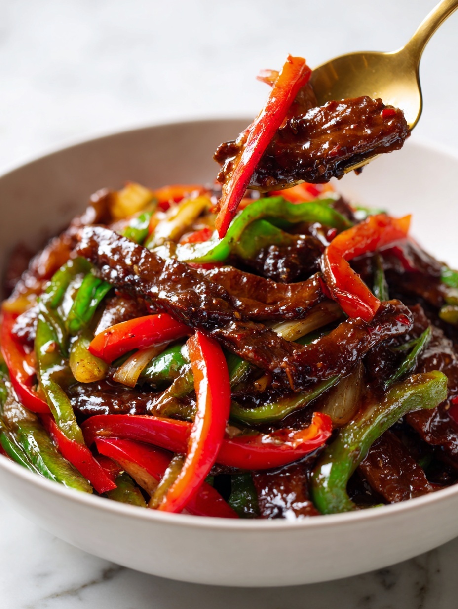 A close-up image of a stir-fry dish in a white bowl showing several thin layers of glossy dark brown beef slices mixed with bright red and green pepper strips, all coated evenly in a shiny thick sauce. The beef pieces have a slightly bumpy texture, while the pepper strips are smooth and crisp-looking, scattered throughout the bowl on a white marbled surface background. photo taken with an iphone --ar 2:3 --v 7