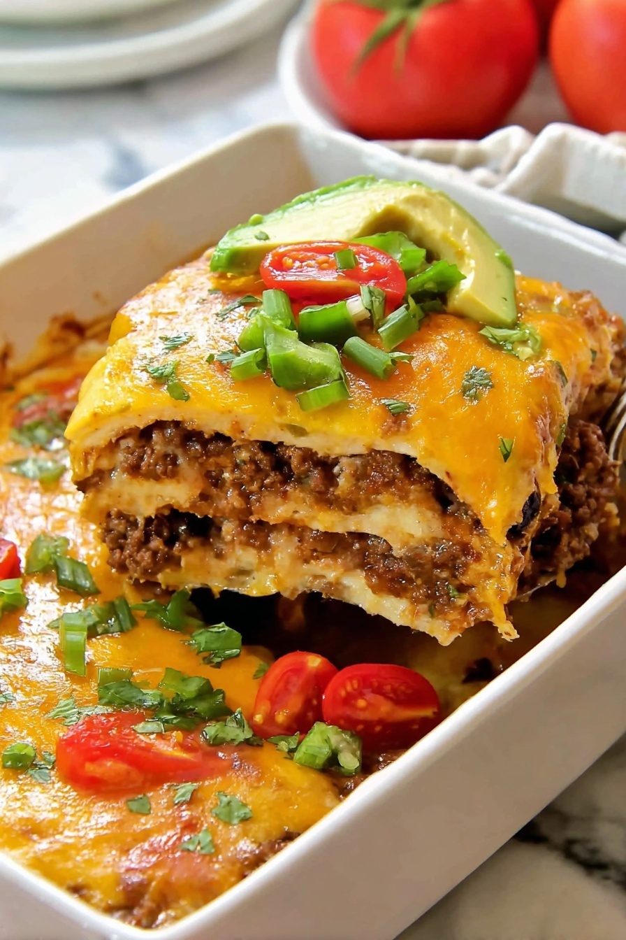 A slice of layered casserole in a white rectangular dish is lifted, showing four thick layers of a mix of browned ground meat and melted cheese with a slightly gooey texture. The top layer is golden melted cheese sprinkled with small green pepper pieces, half of a cherry tomato, and a slice of avocado. On the side inside the dish, there are fresh chopped green peppers and halved cherry tomatoes. The dish sits on a white marbled surface with a soft light in the background. Photo taken with an iphone --ar 2:3 --v 7