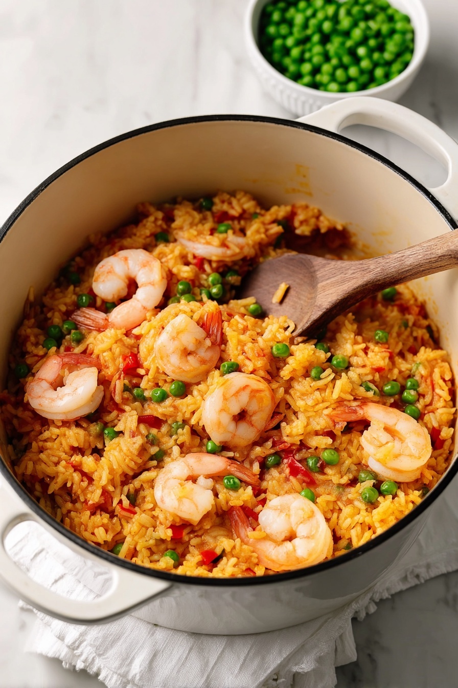 A white pot filled with three visible layers of food: the bottom and middle layers are yellow-orange rice mixed with small pieces of red pepper and green peas scattered throughout, while the top layer has medium-sized shrimp with pink and white tones placed evenly, some partially buried in the rice. A wooden spoon rests inside the pot, showing some rice stuck to it. In the background, there is a white bowl filled with green peas on a white marbled surface with a white cloth underneath the pot. photo taken with an iphone --ar 2:3 --v 7