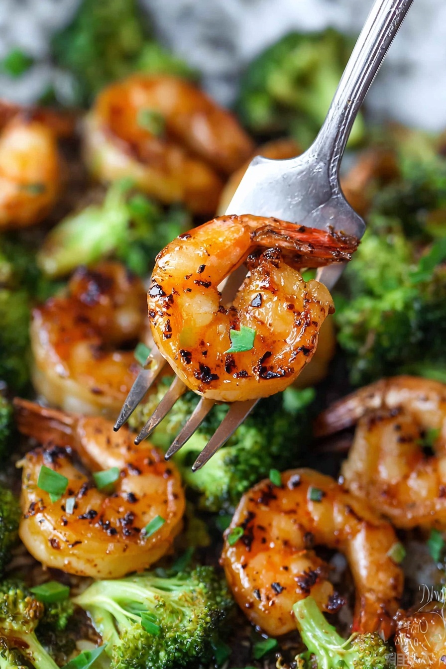 The image shows a close-up of a cooked shrimp with a shiny orange and brown grilled color, speckled with black grill marks, held by a silver fork. Below, there is a mix of bright green broccoli pieces with a slightly charred texture and more grilled orange shrimp scattered around. Small pieces of green garnish add a fresh touch, and all the food sits on a white marbled surface that softly blurs into the background. photo taken with an iphone --ar 2:3 --v 7